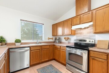 Fototapeta premium A beautiful kitchen with stainless steel appliances and wooden cabinets