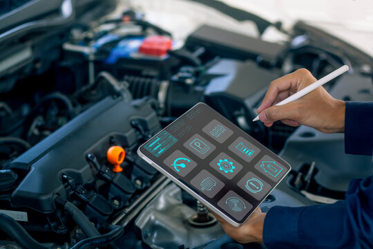 A mechanic uses a digital tablet to diagnose engine performance, monitor system data, and perform smart car maintenance. Ideal for automotive technology, vehicle diagnostics,  - Powered by Adobe