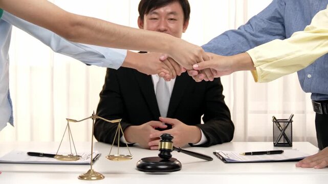 Corporate attorney applaud as business people make a successful deal or agreement with handshake, celebrating mutually beneficial acquisition. Business handshaking concept. Slow motion. Rigid.