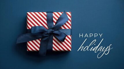 Festive red and white striped gift box tied with a deep blue ribbon on a dark blue background