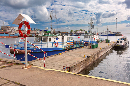 Pilot boats moored at the harbor in Gdynia, Poland with shipyard and marine facilities