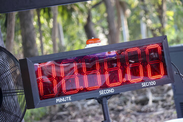 Large digital timer with red display for race countdown. Scoreboard clock shows final second, marking minute for precise time measurement and an exciting finish