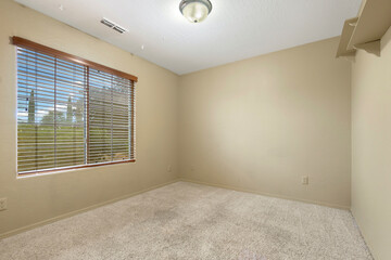 Obraz premium This is an empty bedroom featuring two windows and a ceiling fan
