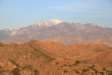 Morning light on San Gorgonio mountain capped with snow as seen from the Mojave desert at Joshua Tree National Park, California