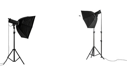 Two photography softboxes stand on tripods against a dark background
