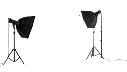 Two photography softboxes stand on tripods against a dark background