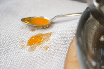 egg spilled on a white tablecloth in a kitchen