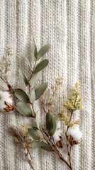 Rustic Cotton Bolls  Eucalyptus Sprigs on Cream Ribbed Knit Fabric, Cozy Hygge Flat Lay.