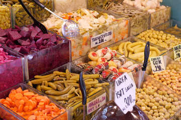 Colorful display of pickled vegetables at market stall