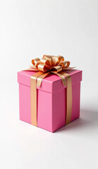 Obraz premium A vibrant pink gift box with a glossy finish, wrapped with an elegant metallic gold ribbon and a neatly tied bow on top.