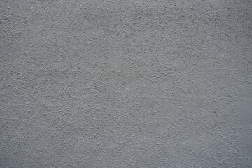 風化と経年劣化によるテクスチャ：少しだけデコボコした壁のクローズアップ