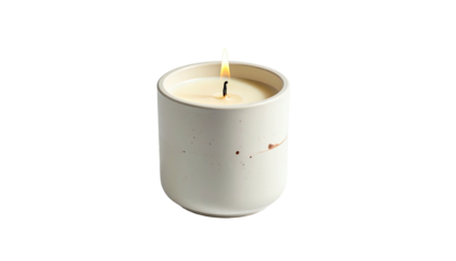 Lit candle in speckled ceramic container against dark backdrop