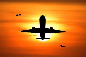 Soaring Silhouettes: An airplane takes flight against the backdrop of a fiery sunset, painting a picture of freedom, travel, and adventure.
