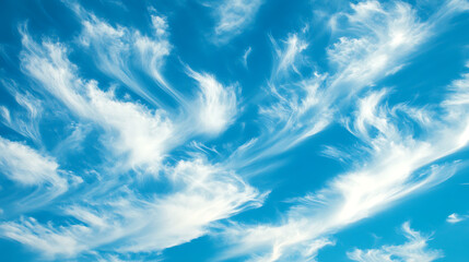 A vibrant, light blue sky, dotted with wispy, feathery white clouds in a delicate, flowing arrangement, clear, bright colors, natural light