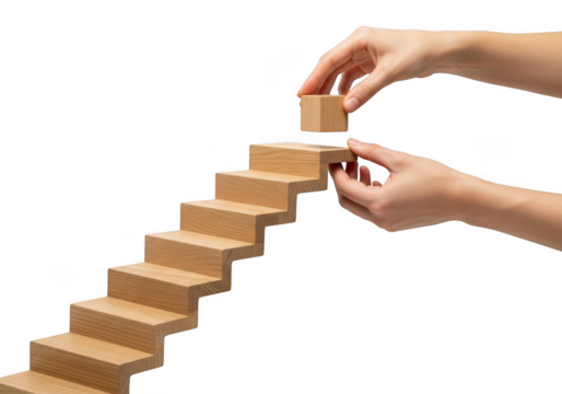 Hands carefully place a wooden block atop a rising staircase structure symbolizing progress and achievement isolated on transparent background