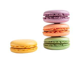 Close-up of four colorful, stacked desserts, with a fifth individual dessert placed to the side against a stark black background