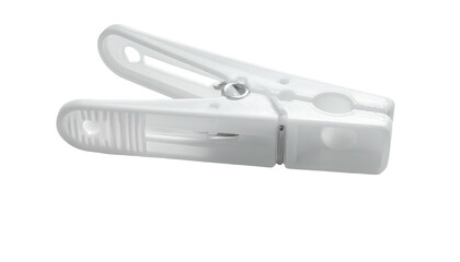White plastic clothespin angled, resting on a dark surface