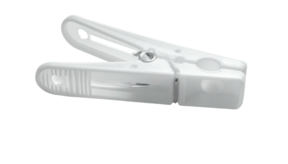 White plastic clothespin angled, resting on a dark surface