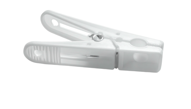 White plastic clothespin angled, resting on a dark surface