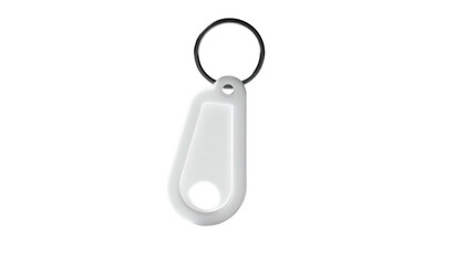 White, rounded, droplet-shaped keytag with ring on dark background