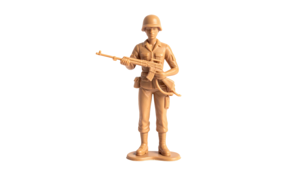 Plastic toy soldier stands poised with rifle against black background