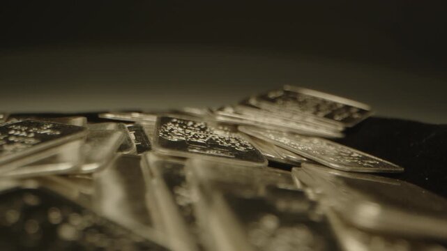 Beautiful dolly of many shiny silver bars used as a tangible investment in a well lit studio