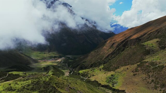 Peruvian Andes range Soray town Laguna Lake Humantay hiking Machu Pichhu Inca snow capped high altitude Salkantay trek Peru aerial drone rainy season sunny morning clouds Cusco forwards motion