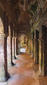 Vertical view through Panam City&rsquo;s deserted brick arcades in Sonargaon, Bangladesh, highlighting historic Indo-Saracenic architecture amid sunlit ruins and quiet streets