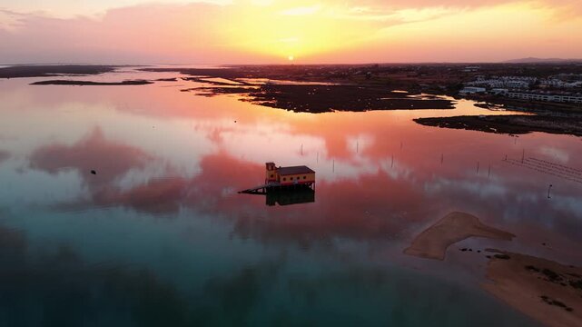 Aerial shot above the life boat station in Fuseta ans Ria Formosa natural park in Algarve region at sunset with beautiful colors, Portugal