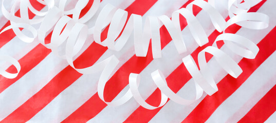 Background with white serpentine and red stripes, selective focus