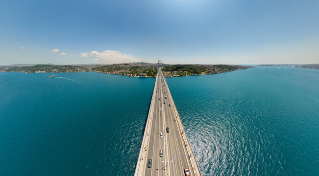 Istanbul, Turkey. Panoramic aerial view of Asian shore from Bosphorus Bridge with busy traffic. Cars on bridge, Uskudar district, Camlica Hill, Bosphorus strait with ships. Aerial view