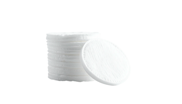 Stack of cotton pads, one leaning, on a black background