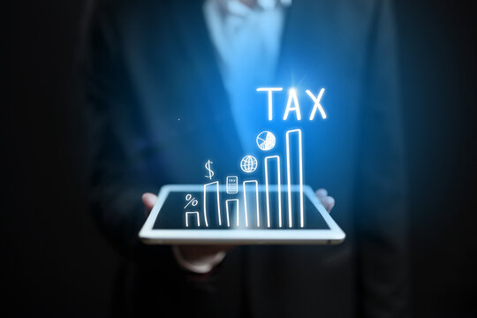 Businessman using tablet to analyze tax data in a professional setting