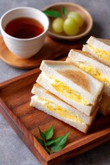 Close-Up of Japanese Egg Sandwich with Sliced Bread and Tea