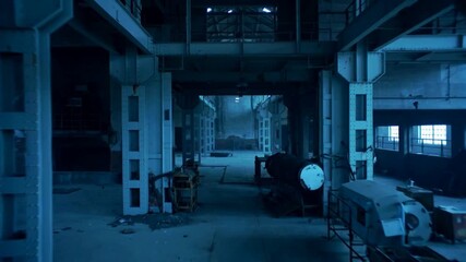 The camera glides through an abandoned factory lit by cool overhead lights. Metal surfaces reflect blue-gray tones. Cinematic live-action, desaturated steel palette, gritty film style.