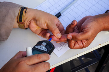 Checking Blood Sugar Level with Glucometer for Diabetes Management at Home