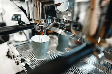 Espresso brewing process in a modern coffee shop during the morning rush
