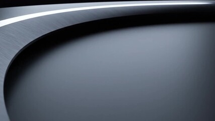 Abstract close-up of a sleek, curved surface with contrasting light and shadow, suggesting modern design
