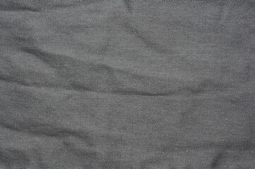 Close-up of gray denim fabric with diagonal weave texture