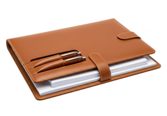 Elegant tan leather bound journal with two matching pens and a secure strap closure isolated on transparent background