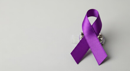 Epilepsy awareness month with purple ribbon signifies support and understanding, during epilepsy awareness month. Satin ribbon pin represents strength for epilepsy awareness month.