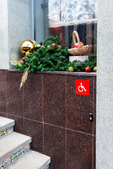 Festive window display with accessibility sign and tiled stairs