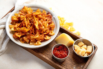 Crunchy fried pasta chips with dips.