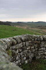 Landscape view of ancient monument Hadrian&rsquo;s Wall. the rugged Scottish highland countryside, a dramatic historical landmark set against a windswept moorland backdrop