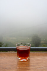 Glass of Hot Tea with Misty Mountain Backdrop in Sa Pa, Vietnam
