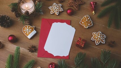Christmas cookies envelope pine branches and lit candle on wooden table greeting card preparation - Powered by Adobe