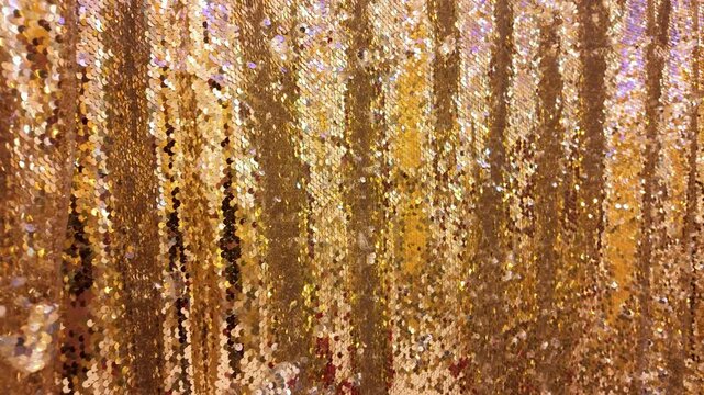 Golden glitter curtain backdrop with sparkling sequin texture for festive events and glamorous celebrations
