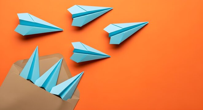 Several blue paper airplanes emerge from a brown envelope against a vibrant orange background, suggesting concepts of flight, ideas, or travel.