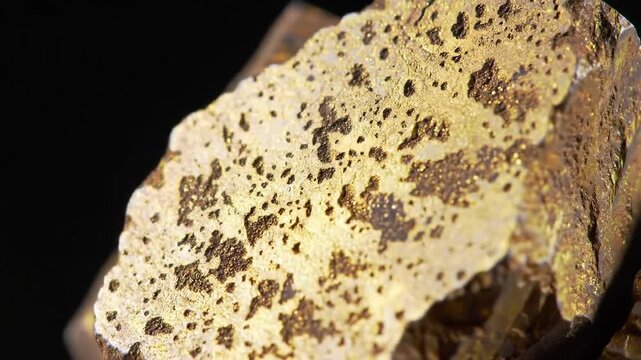 Detailed macro shot of raw chalcopyrite mineral rock featuring a metallic sheen, golden color, and rough texture on a dark background, perfect for geological study.