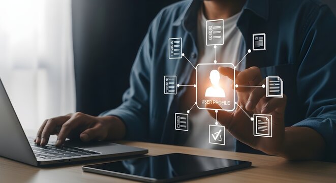 A man works on a laptop with a digital interface displaying a profile and documents, suggesting data management or online identity.